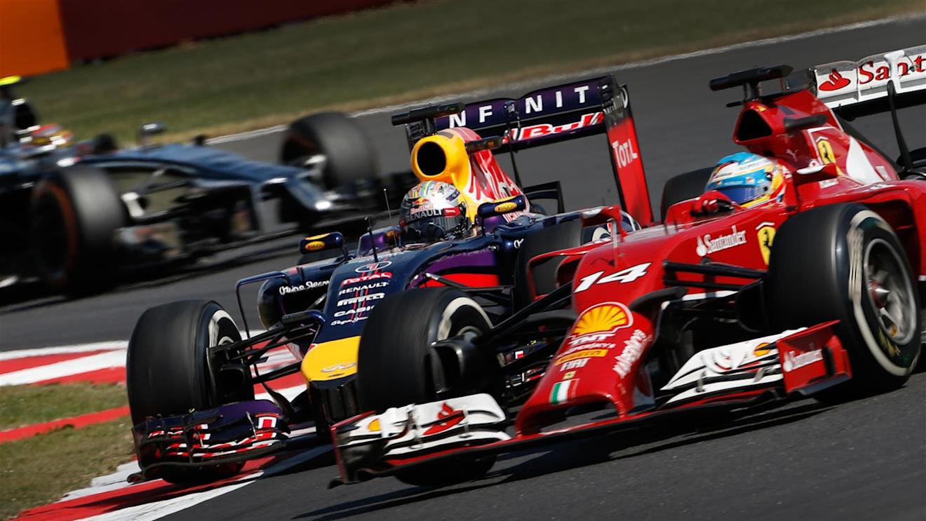 Sebastian Vettel (GER) Red Bull Racing RB10 and Fernando Alonso (ESP) Ferrari F14 T battle. Formula One World Championship, Rd9, British Grand Prix, Race Day, Silverstone, England, Sunday, 6 July 2014