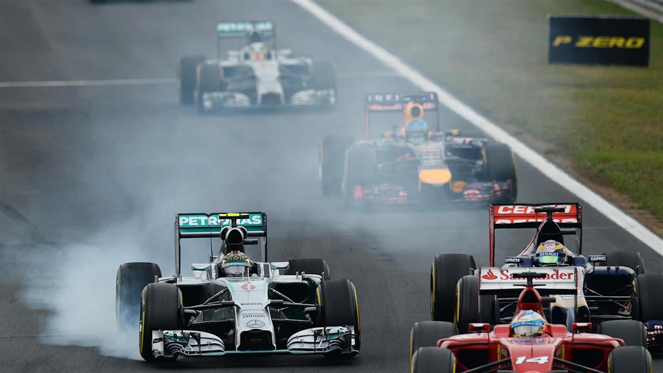 Nico Rosberg (GER) Mercedes AMG F1 W05 locks up and battles with Jean-Eric Vergne (FRA) Scuderia Toro Rosso STR9. Formula One World Championship, Rd11, Hungarian Grand Prix, Race Day, Hungaroring, Hungary. Sunday, 27 July 2014
