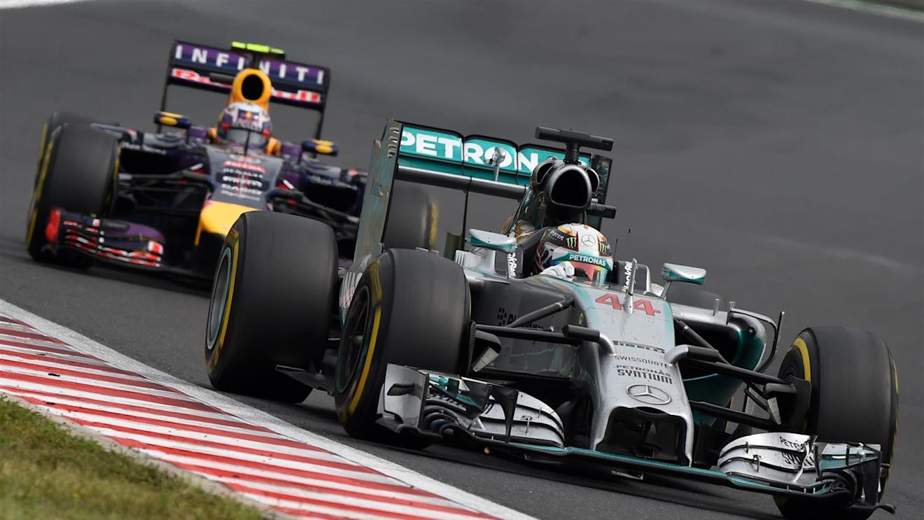 Lewis Hamilton (GBR) Mercedes AMG F1 W05 leads Daniel Ricciardo (AUS) Red Bull Racing RB10. Formula One World Championship, Rd11, Hungarian Grand Prix, Race Day, Hungaroring, Hungary. Sunday, 27 July 2014