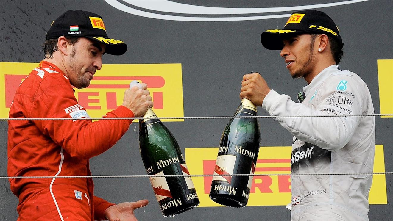 Fernando Alonso (ESP) Ferrari and Lewis Hamilton (GBR) Mercedes AMG F1 celebrate on the podium with the champagne. Formula One World Championship, Rd11, Hungarian Grand Prix, Race Day, Hungaroring, Hungary. Sunday, 27 July 2014