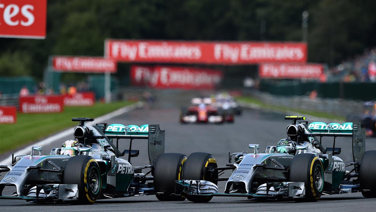 (L to R): Lewis Hamilton (GBR) Mercedes AMG F1 W05 and Nico Rosberg (GER) Mercedes AMG F1 W05 battle at Les Coombes on lap 2. Rosberg damaged his front wing and punctured the left rear wheel of Hamilton's car in the process. Formula One World Championship, Rd12, Belgian Grand Prix, Race Day, Spa-Francorchamps, Belgium, Sunday, 24 August 2014