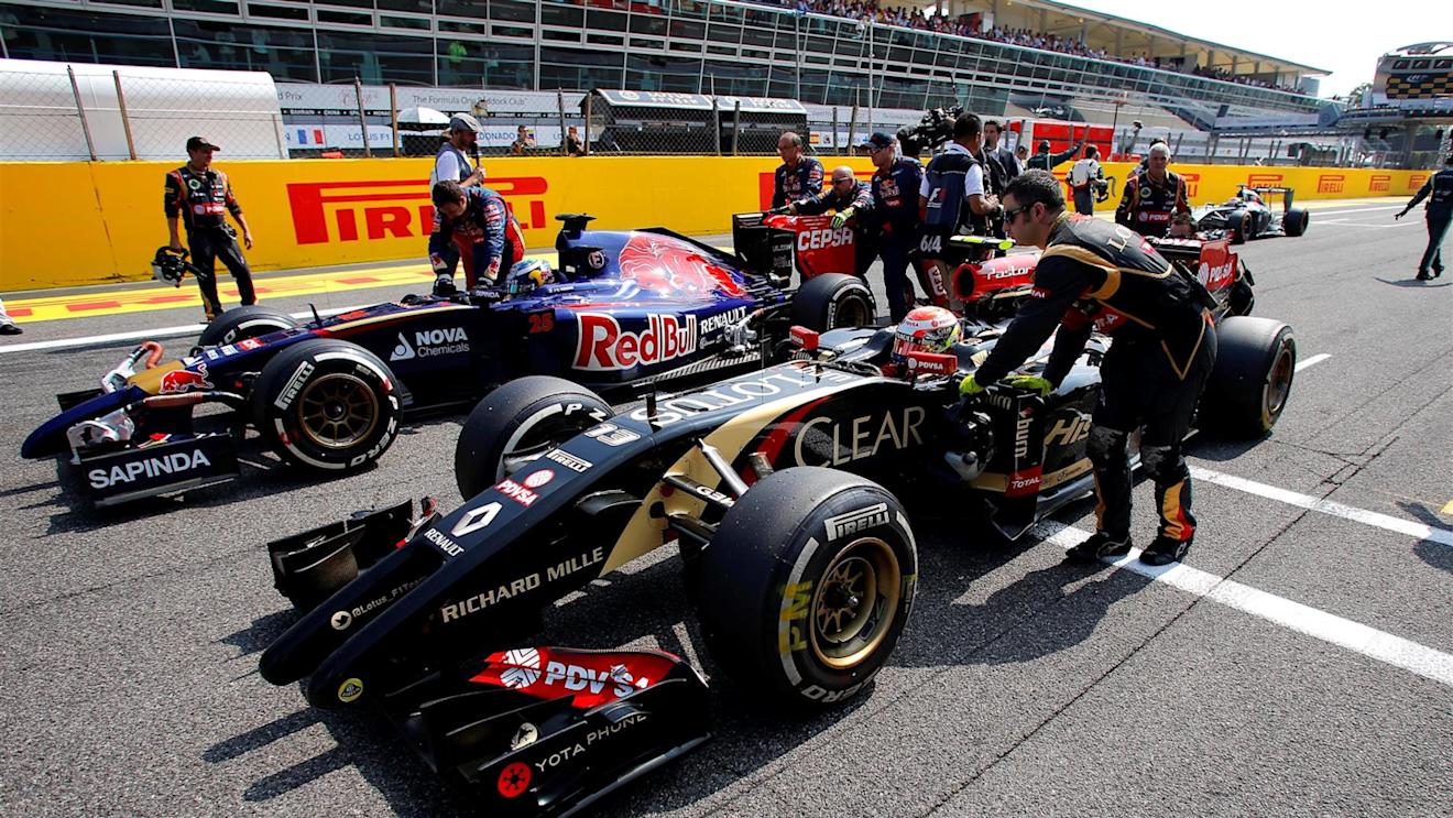 Pastor Maldonado (VEN) Lotus E22 and Jean-Eric Vergne (FRA) Scuderia Toro Rosso STR9 on the grid. Formula One World Championship, Rd13, Italian Grand Prix, Monza, Italy, Race Day, Sunday, 7 September 2014
