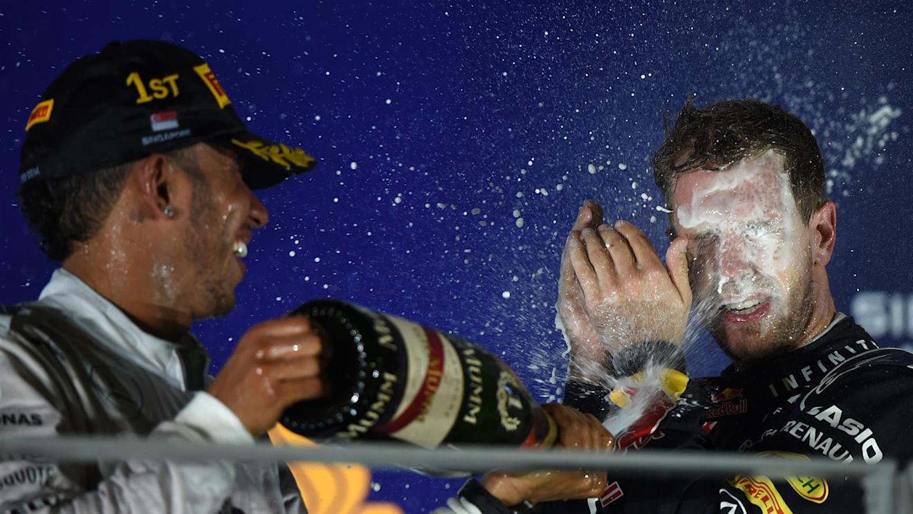 Race winner Lewis Hamilton (GBR) Mercedes AMG F1 celebrates on the podium with Sebastian Vettel (GER) Red Bull Racing and the champagne. Formula One World Championship, Rd14, Singapore Grand Prix, Marina Bay Street Circuit, Singapore, Race Day, Sunday, 21 September 2014