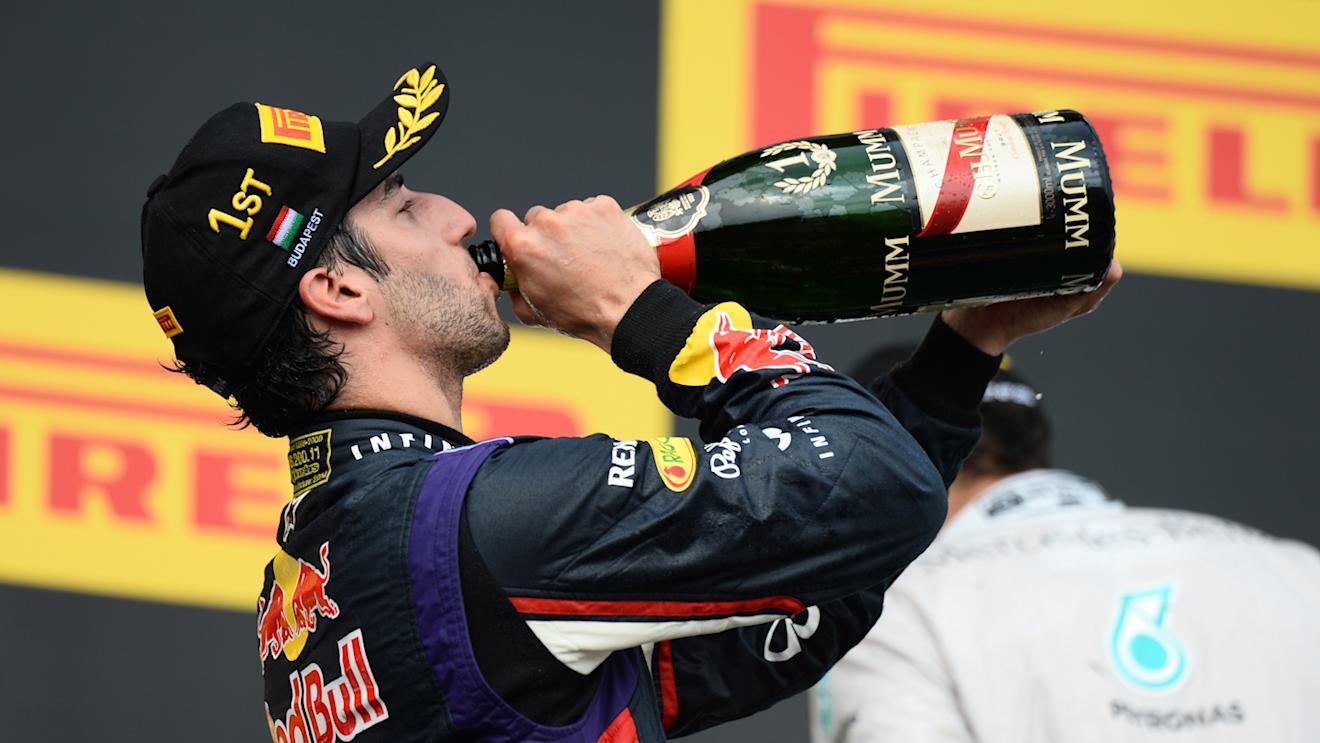 Race winner Daniel Ricciardo (AUS) Red Bull Racing celebrates on the podium with the champagne. Formula One World Championship, Rd11, Hungarian Grand Prix, Race Day, Hungaroring, Hungary. Sunday, 27 July 2014