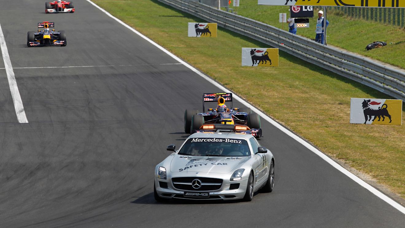 The Safety Car leads Mark Webber, Red Bull Racing RB6 Renault, 1st position, Sebastian Vettel, Red Bull Racing RB6 Renault, 3rd position, and Fernando Alonso, Ferrari F10, 2nd position. © LAT Photographic
