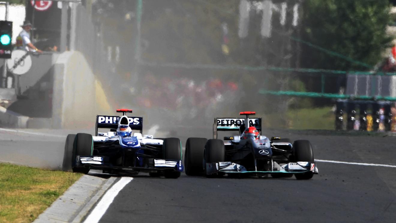 Michael Schumacher (GER) Mercedes GP MGP W01 squeezes Rubens Barrichello (BRA) Williams FW32 into the pit wall and onto the grass.
Hungarian Grand Prix, Race, Budapest, Hungary, Sunday 1 August 2010. ©  Sutton Motorsport Images