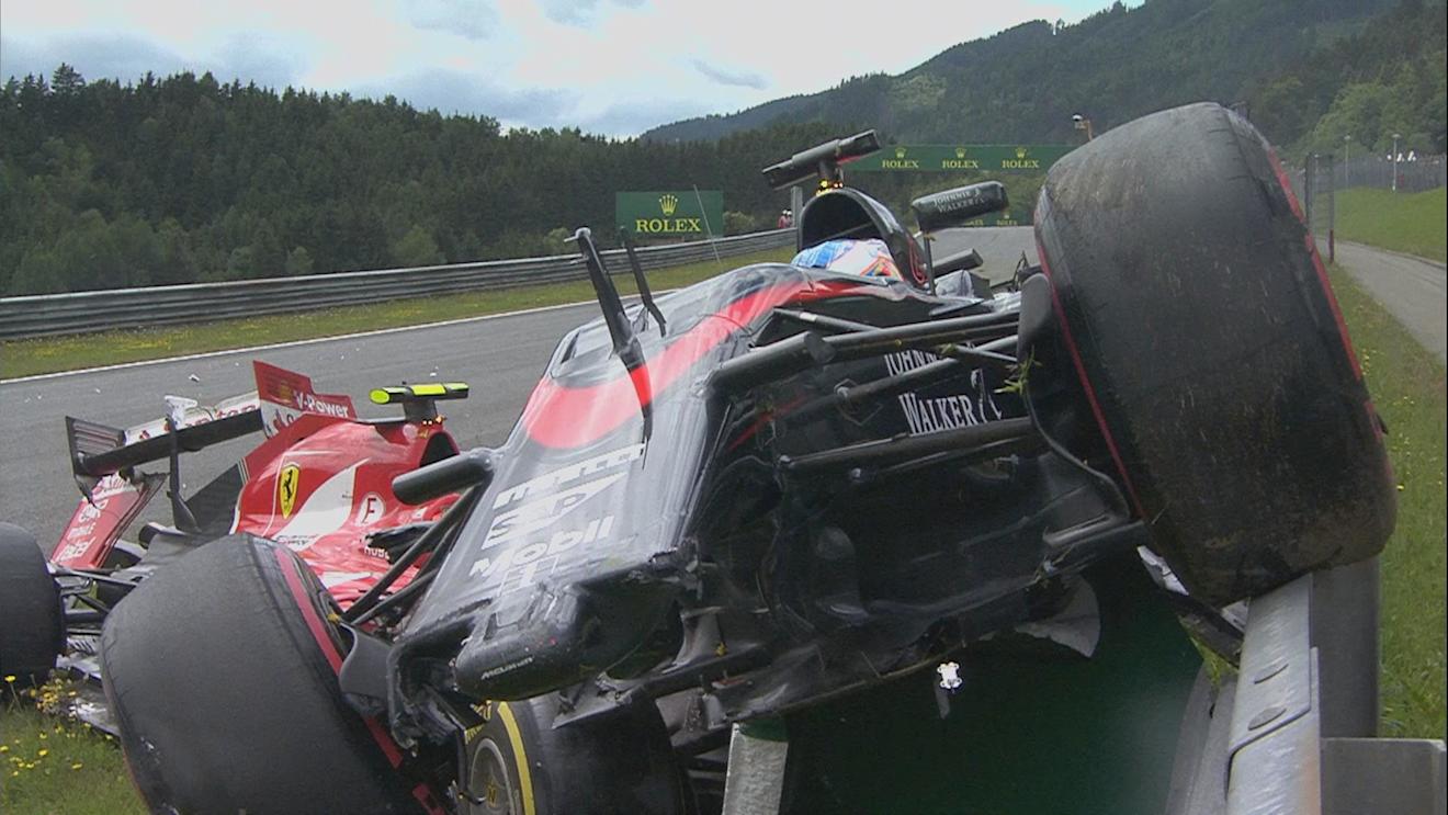 Fernando Alonso's McLaren ended up parked on the barriers after a collision with Ferrari's Kimi Raikkonen on lap one in Austria