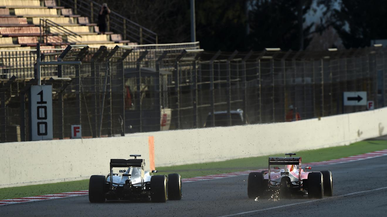 Nico Rosberg (GER) Mercedes AMG F1 W06 and Sebastian Vettel (GER) Ferrari SF15-T with sparks at Formula One Testing, Day Four, Barcelona, Spain, 1 March 2015.
