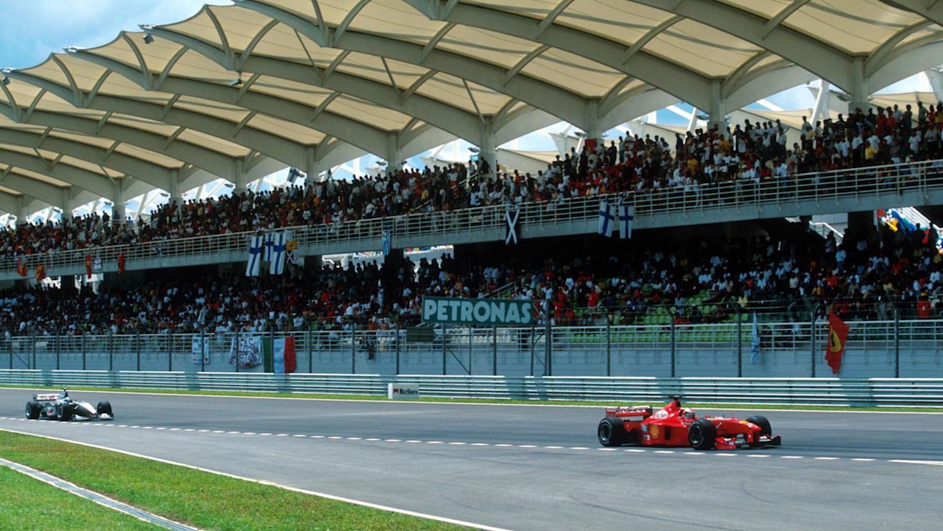 Michael Schumacher(GER) Ferrari F399 leads Hakkinen in front of the impressive Grandstand
Malaysian GP, Sepang, 17 October 1999 © ©Sutton Motorsport Images