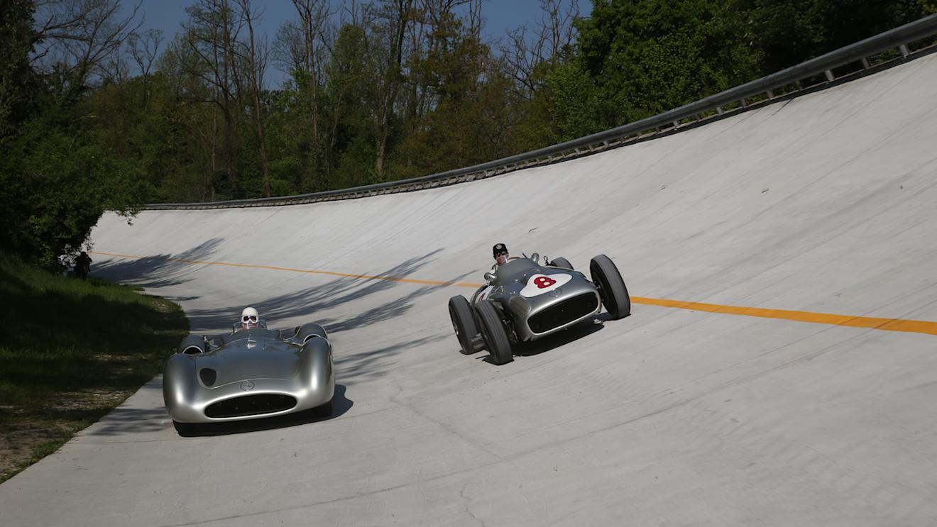 Stirling Moss (left) and Lewis Hamilton (right) sample the Mercedes W196 - in streamliner and open-wheel form - on the famous Monza banking © Daimler AG
