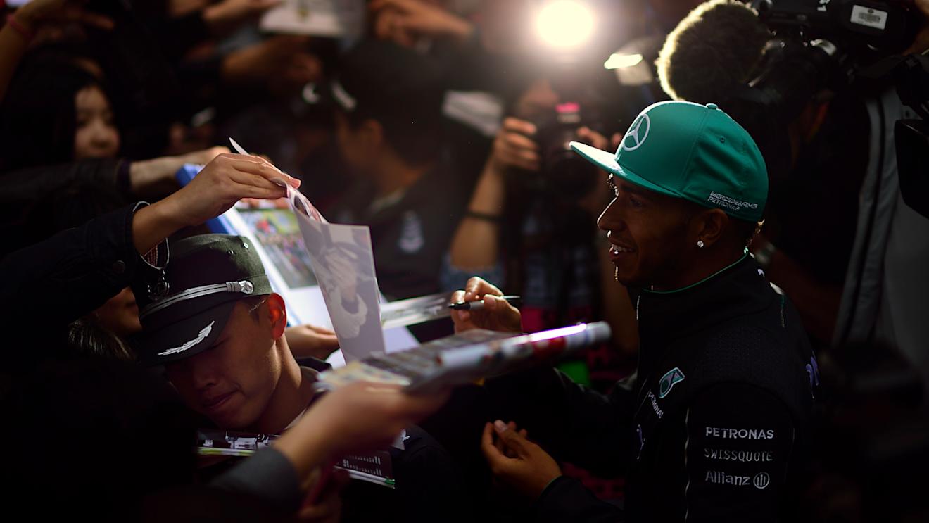 Mercedes' Lewis Hamilton signs autographs for fans © FOWC Ltd