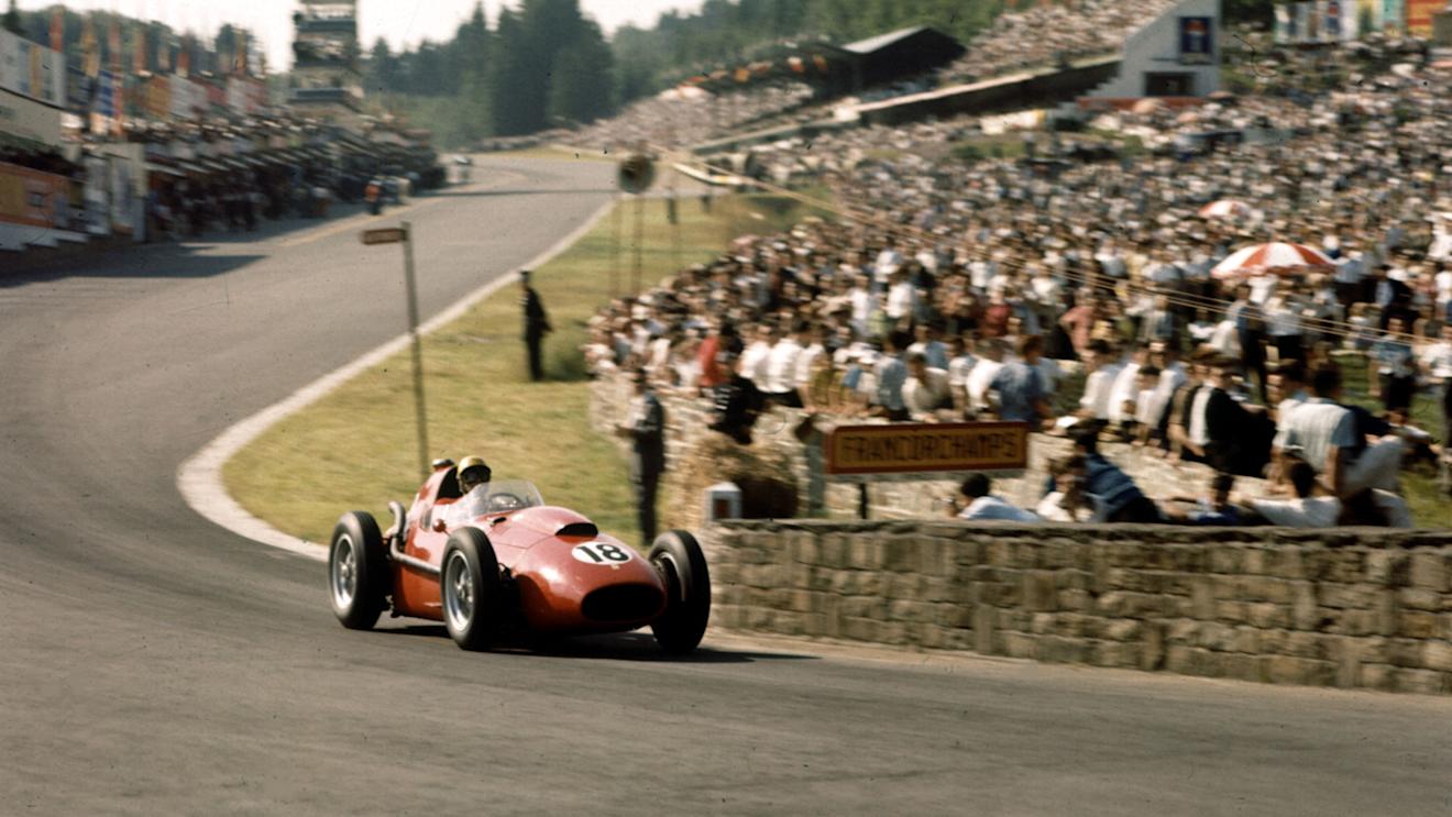 Luigi Musso (Ferrari Dino 246) crosses the bridge at the bottom of the hill. 1958 Belgian Grand Prix, Spa-Francorchamps. © LAT Photographic