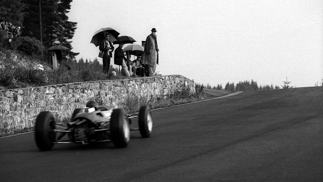 Despite the poor weather, a group of spectators have an unparalleled view of the action at the top of Eau Rouge. Note the stone wall. Belgian Grand Prix, Spa-Francorchamps, 9 June 1963. ©Sutton Motorsport Images