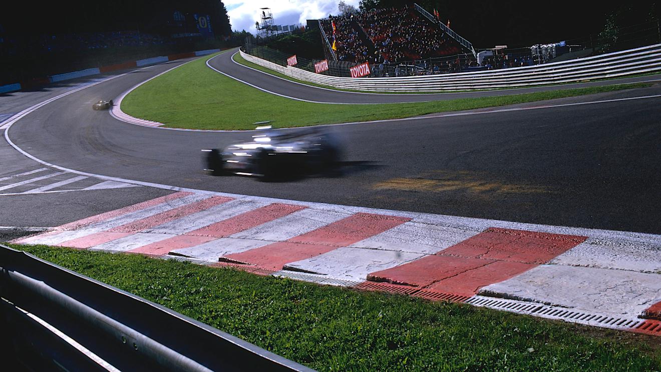 Cars fly through the newly revised Eau Rouge flat out in 2002. Patches are left where the wooden planks scrape the track surface. © LAT Photographic
