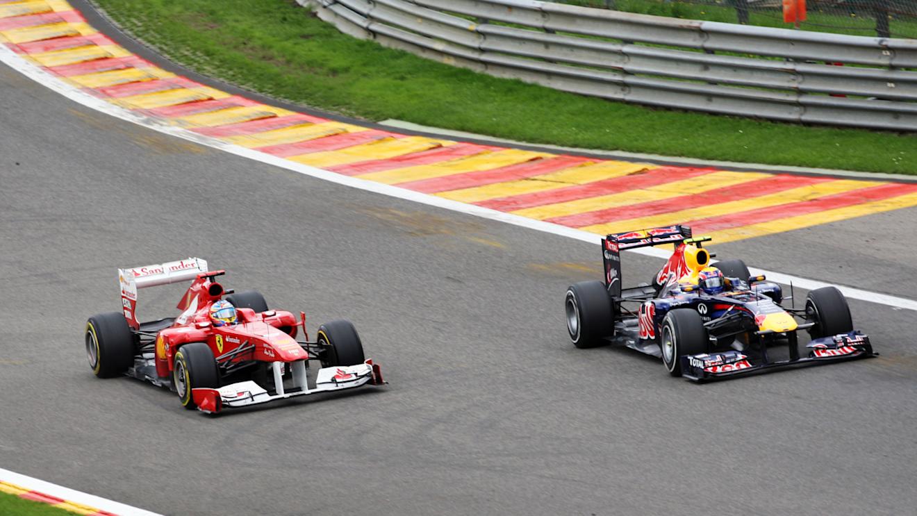 Mark Webber (right) completes a daring overtake on Fernando Alonso heading into Eau Rouge during the 2011 Belgian Grand Prix. © Sutton Motorsport Images