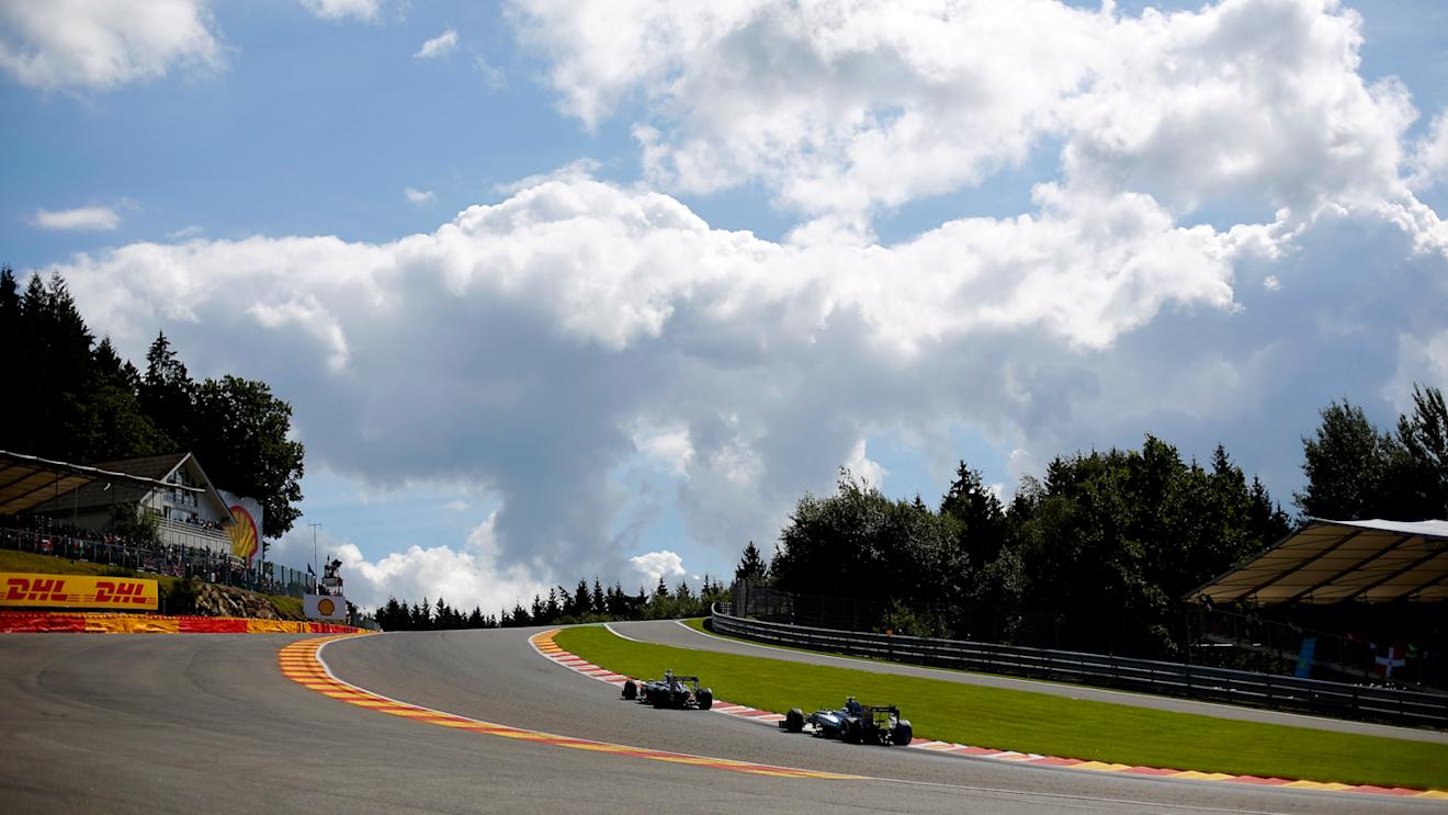 Jenson Button (GBR) McLaren MP4-29 leads Nico Rosberg (GER) Mercedes AMG F1 W05 through Eau Rouge in 2014. © Sutton Motorsport Images
