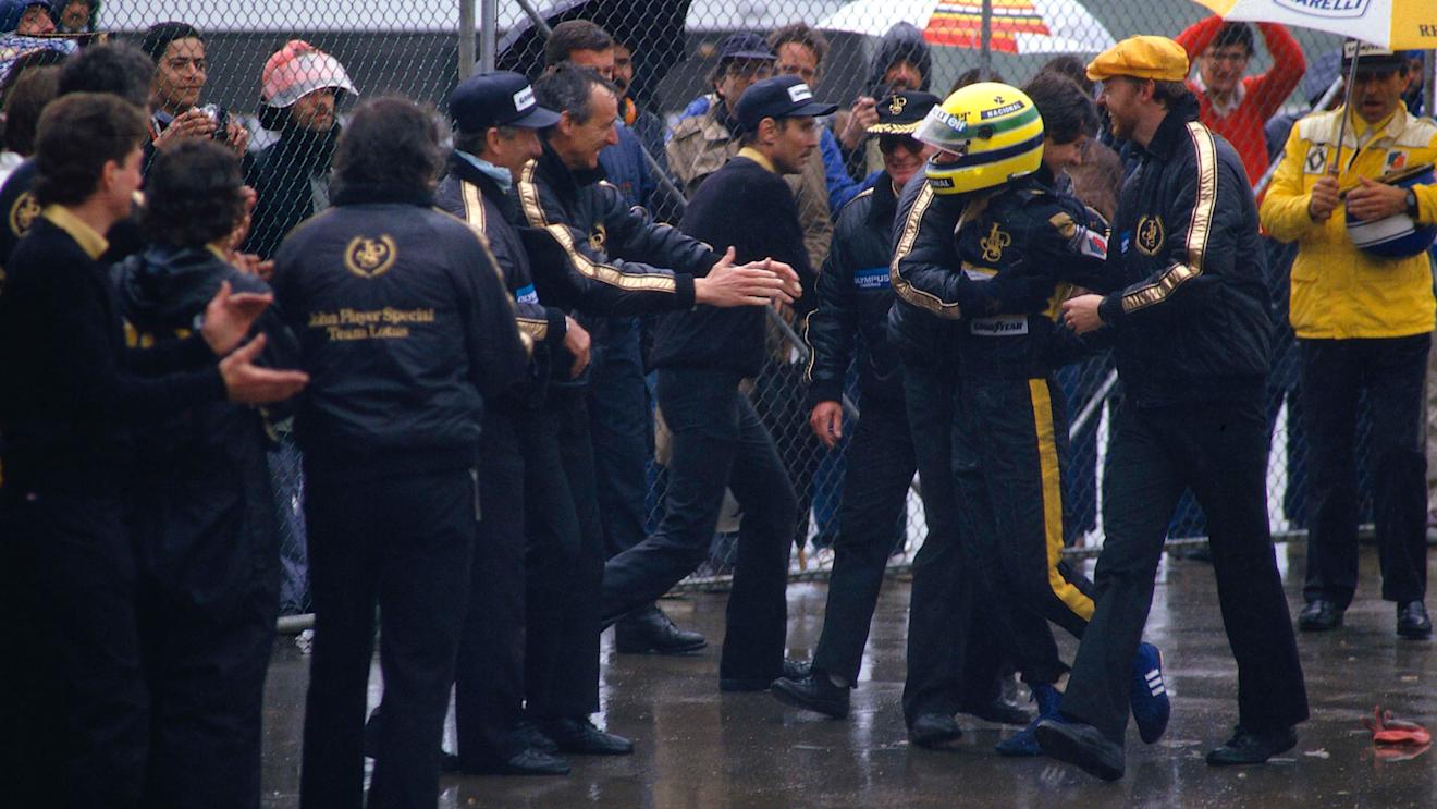 Ayrton Senna (Lotus Renault) is mobbed by Lotus team colleagues in parc ferme. Steve Hallam is wearing the yellow hat on the right of the picture. Copyright: LAT Photographic
