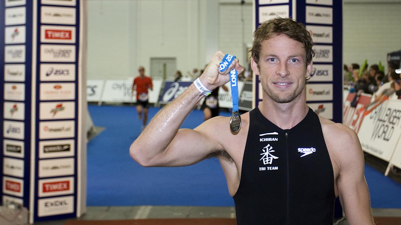 Jenson Button proudly displays his medal after completing the 2010 London Triathlon in aid of Make-A-Wish Foundation UK. © Sutton Motorsport Images