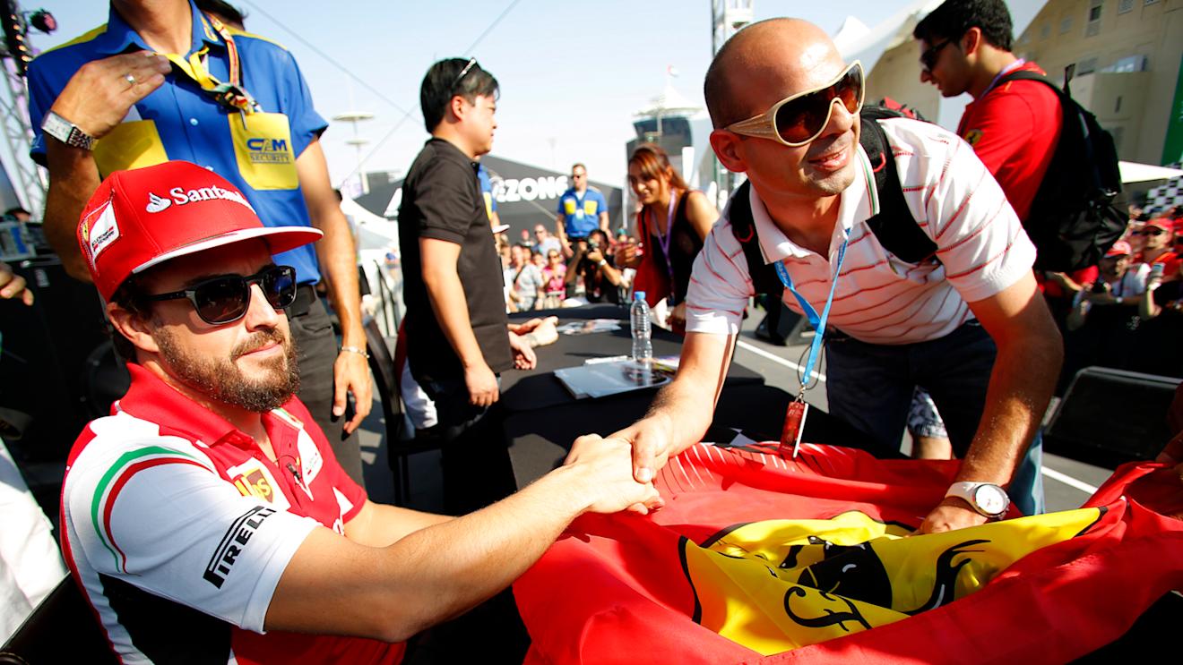 Fernando Alonso (ESP) Ferrari at the drivers autograph session. Formula One World Championship, Rd19, Abu Dhabi Grand Prix, Preparations, Yas Marina Circuit, Abu Dhabi, UAE, Thursday, 20 November 2014 
