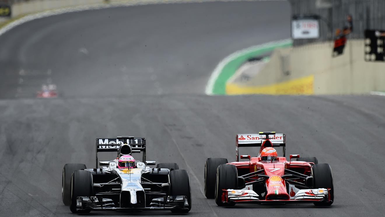 Jenson Button (GBR) McLaren MP4-29 and Kimi Raikkonen (FIN) Ferrari F14 T battle. Formula One World Championship, Rd18, Brazilian Grand Prix, Race, Sao Paulo, Brazil, Sunday, 9 November 2014
