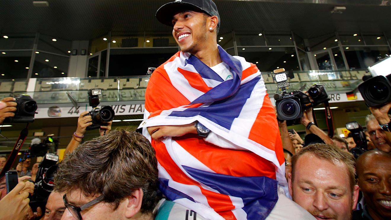 Lewis Hamilton (GBR) Mercedes AMG F1 celebrates with the team. Formula One World Championship, Rd19, Abu Dhabi Grand Prix, Race, Yas Marina Circuit, Abu Dhabi, UAE, Sunday, 23 November 2014 