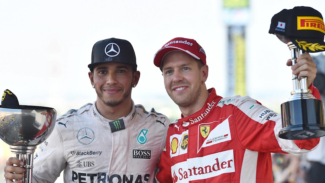 Race winner Lewis Hamilton (GBR) Mercedes AMG F1 and Sebastian Vettel (GER) Ferrari celebrate on the podium with the trophies at Formula One World Championship, Rd14, Japanese Grand Prix, Race, Suzuka, Japan, Sunday 27 September 2015. © Sutton Motorsport Images