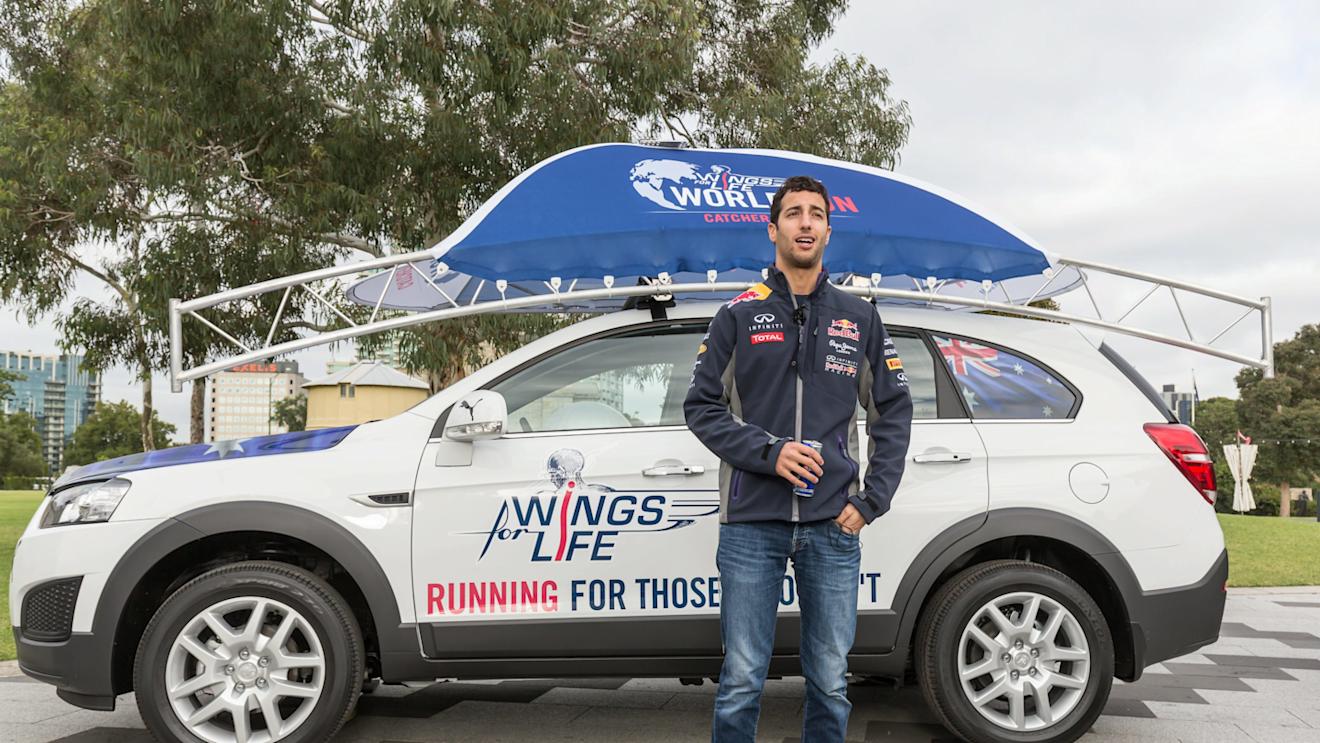 Daniel Ricciardo poses for a portrait infront of the chase car during the Daniel Ricciardo x Wings for Life World Run activation at the Botanical Gardens, Melbourne on March 10th, 2015 © Mark Dadswell for Wings for Life World Run