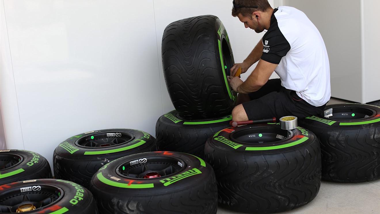 A McLaren machnic prepare a green colored intermediate Pirelli tyre at Formula One World Championship, Rd4, Bahrain Grand Prix Preparations, Bahrain International Circuit, Sakhir, Bahrain, Thursday 16  April 2015. © Sutton Motorsport Images