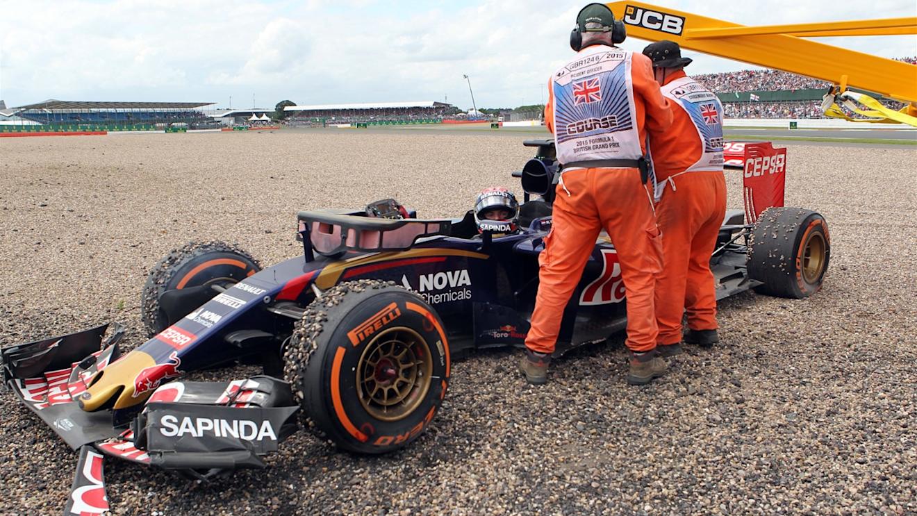 Marshals attend to Max Verstappen (NDL) Scuderia Toro Rosso STR10 after crashing into the gravel at Formula One World Championship, Rd9, British Grand Prix, Race, Silverstone, England, Sunday 5 July 2015. © Sutton Motorsport Images
