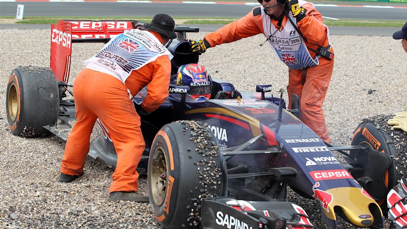 Marshals attend to Max Verstappen (NDL) Scuderia Toro Rosso STR10 after crashing into the gravel at Formula One World Championship, Rd9, British Grand Prix, Race, Silverstone, England, Sunday 5 July 2015. © Sutton Motorsport Images