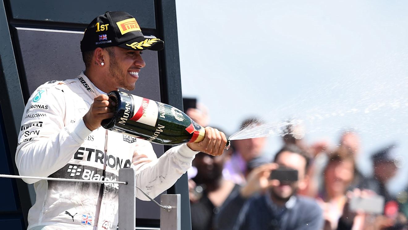 Race winner Lewis Hamilton (GBR) Mercedes AMG F1 celebrates on the podium with the champagne Formula One World Championship, Rd9, British Grand Prix, Race, Silverstone, England, Sunday 5 July 2015. © Sutton Motorsport Images
