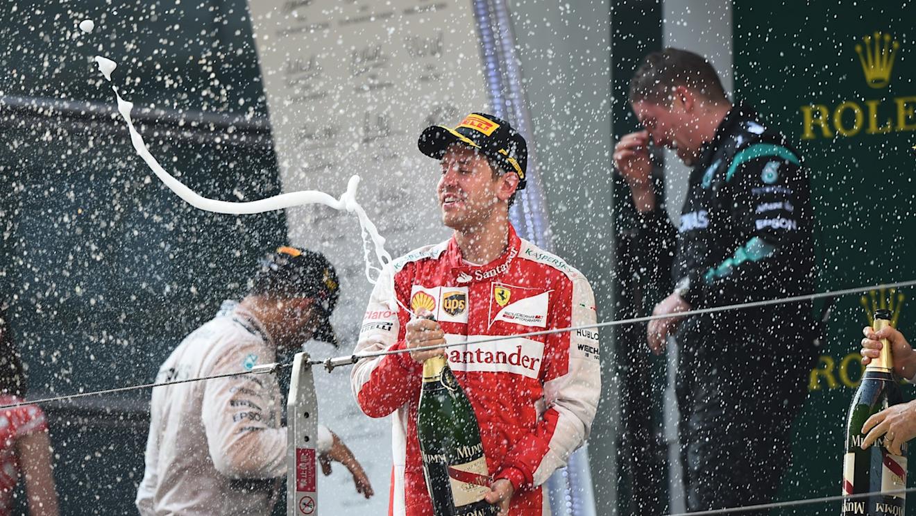 Sebastian Vettel (GER) Ferrari celebrates on the podium with the champagne at Formula One World Championship, Rd3, Chinese Grand Prix, Race, Shanghai, China, Sunday 12 April 2015. © Sutton Motorsport Images