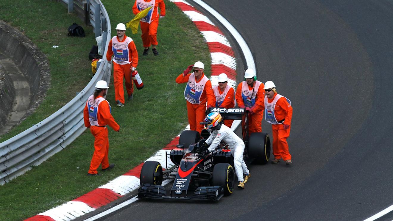 Marshalls and Fernando Alonso (ESP) McLaren MP4-30 push his car in Q2 at Formula One World Championship, Rd10, Hungarian Grand Prix, Qualifying, Hungaroring, Hungary, Saturday 25 July 2015. © Sutton Motorsport Images