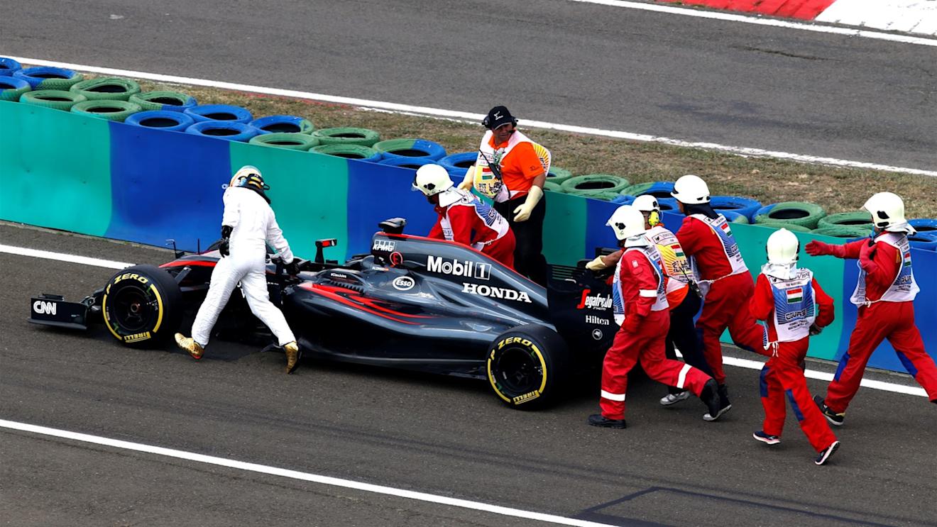 Marshalls and Fernando Alonso (ESP) McLaren MP4-30 push his car in Q2 at Formula One World Championship, Rd10, Hungarian Grand Prix, Qualifying, Hungaroring, Hungary, Saturday 25 July 2015. © Sutton Motorsport Images