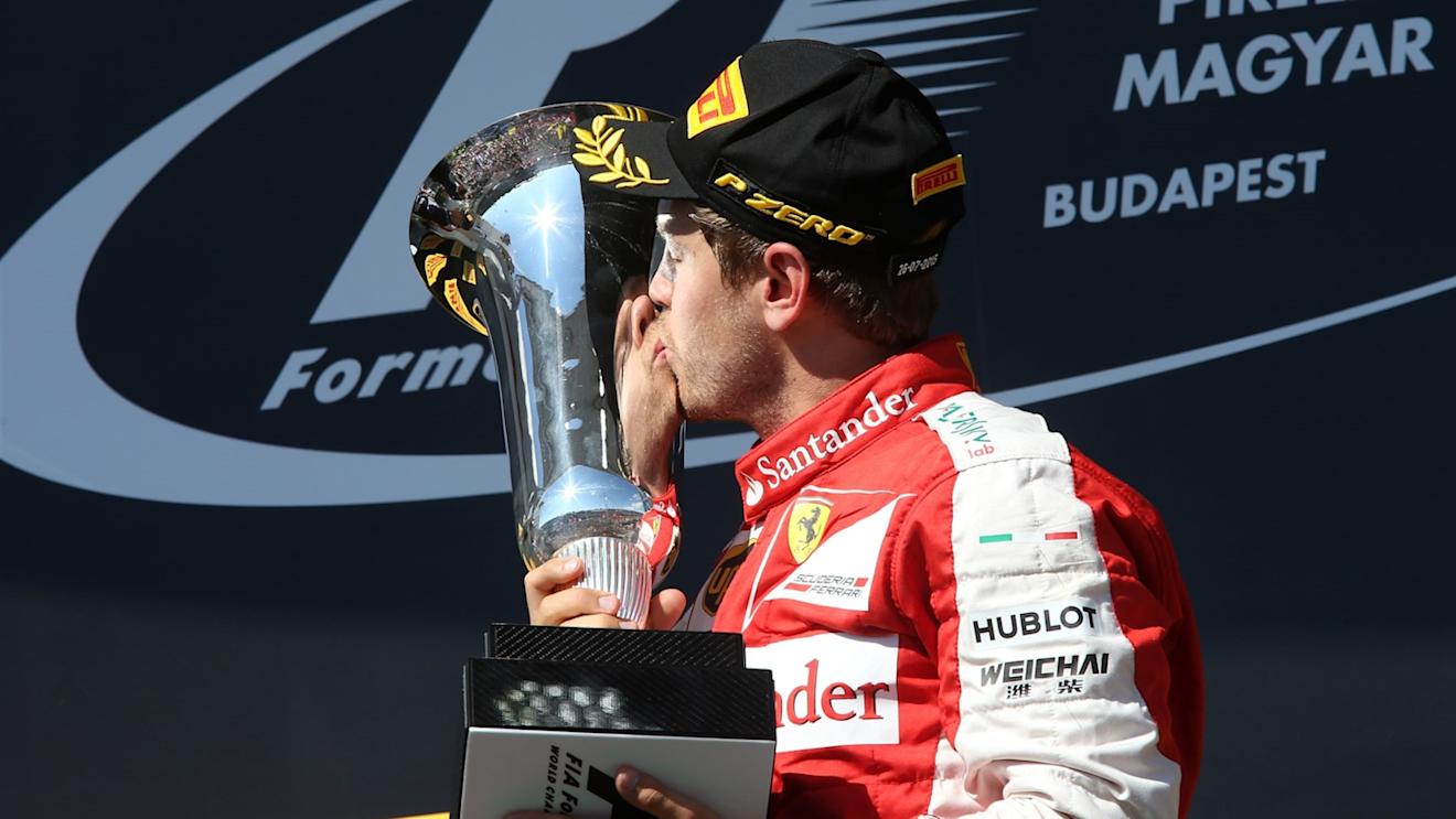 Race winner Sebastian Vettel (GER) Ferrari celebrates and kisses the trophy on the podium at Formula One World Championship, Rd10, Hungarian Grand Prix, Race, Hungaroring, Hungary, Sunday 26 July 2015. © Sutton Motorsport Images