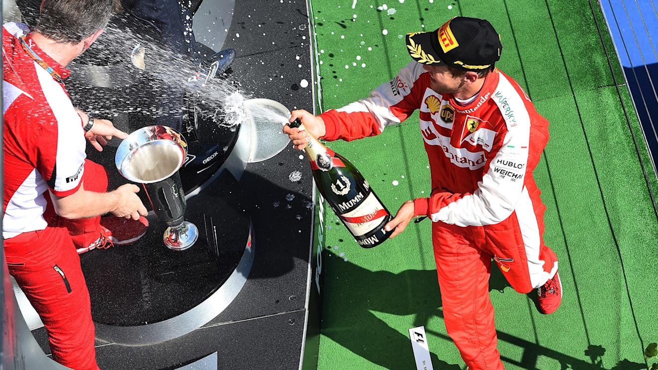 Race winner Sebastian Vettel (GER) Ferrari celebrates on the podium with the champagne at Formula One World Championship, Rd10, Hungarian Grand Prix, Race, Hungaroring, Hungary, Sunday 26 July 2015. © Sutton Motorsport Images