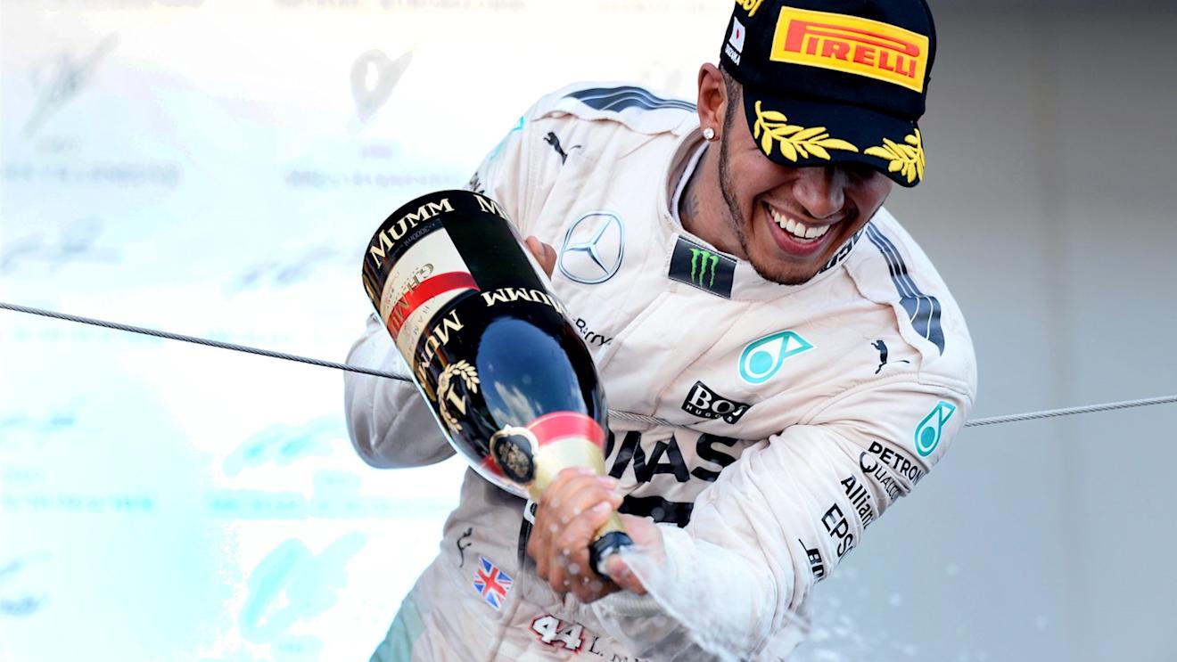 Race winner Lewis Hamilton (GBR) Mercedes AMG F1 celebrates on the podium with champagne at Formula One World Championship, Rd14, Japanese Grand Prix, Race, Suzuka, Japan, Sunday 27 September 2015. © Sutton Motorsport Images