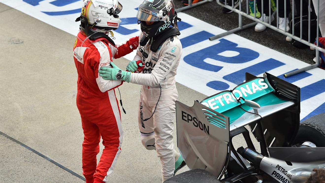 Sebastian Vettel (GER) Ferrari and Nico Rosberg (GER) Mercedes AMG F1 celebrate in parc ferme at Formula One World Championship, Rd14, Japanese Grand Prix, Race, Suzuka, Japan, Sunday 27 September 2015. © Sutton Motorsport Images