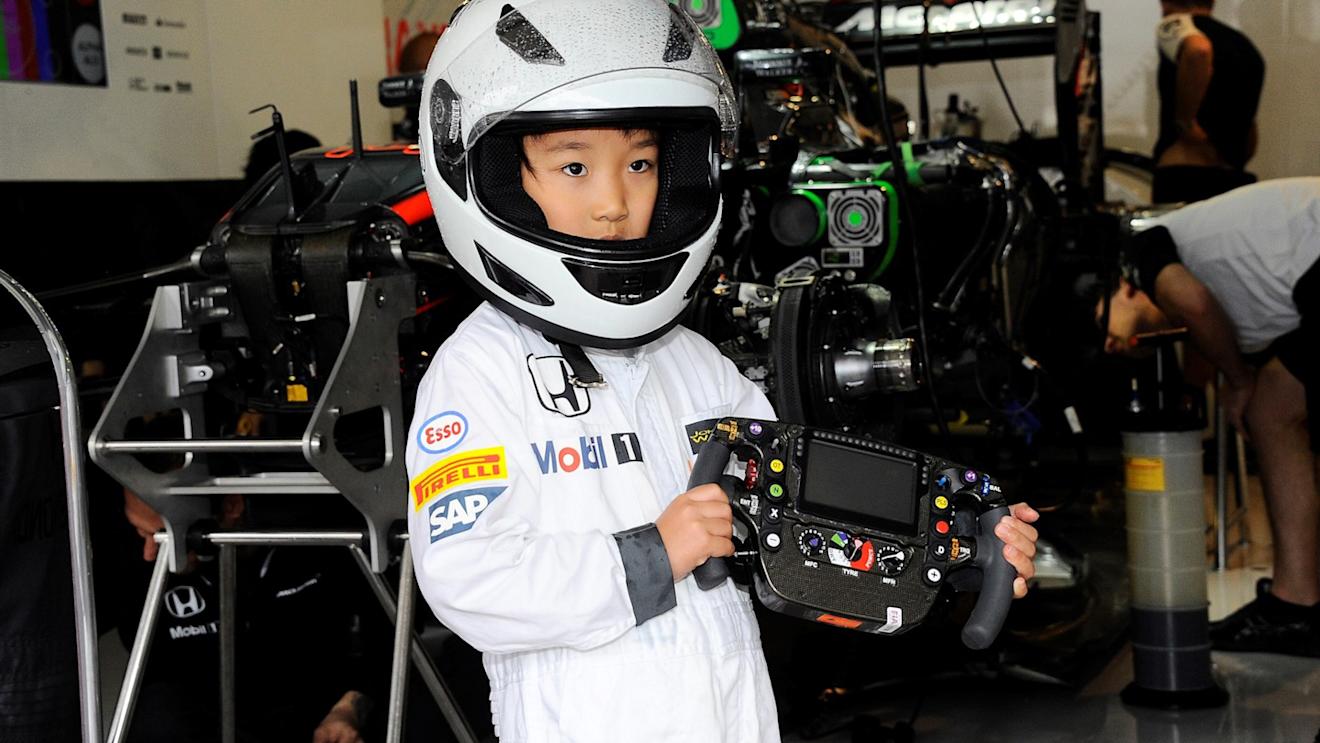Young fan with McLaren MP4-30 steering wheel at Formula One World Championship, Rd14, Japanese Grand Prix, Preparations, Suzuka, Japan, Thursday 24 September 2015. © Sutton Motorsport Images