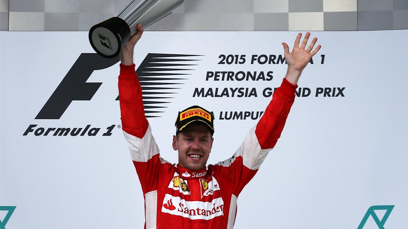 Race winner Sebastian Vettel (GER) Ferrari celebrates on the podium with the trophy at Formula One World Championship, Rd2, Malaysian Grand Prix, Race, Sepang, Malaysia, Sunday 29 March 2015. © Sutton Motorsport Images