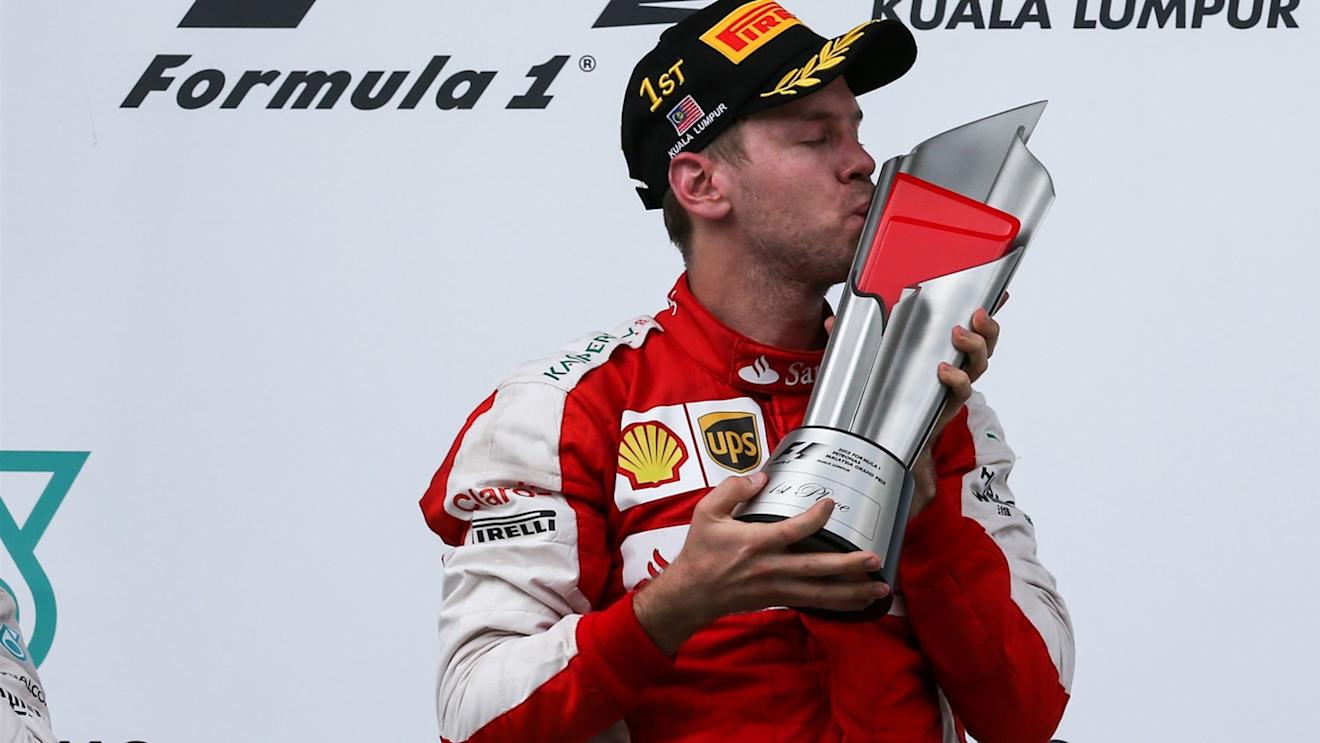 Race winner Sebastian Vettel (GER) Ferrari celebrates on the podium with the trophy at Formula One World Championship, Rd2, Malaysian Grand Prix, Race, Sepang, Malaysia, Sunday 29 March 2015. © Sutton Motorsport Images