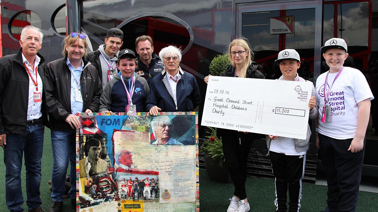 Keith Sutton (GBR) Sutton Images CEO and Mark Dickens (GBR) Artist with Bernie Ecclestone (GBR) CEO Formula One Group (FOM) who presents a cheque for Fifteen Thousand Pounds to Sinead O'Callaghan (IRL) Great Ormond Street Childrens Hospital raised by the sale of The World Champions in Art Collection Bernie Ecclestone art piece at Formula One World Championship, Rd10, British Grand Prix, Practice, Silverstone, England, Friday 8 July 2016. © Sutton Images