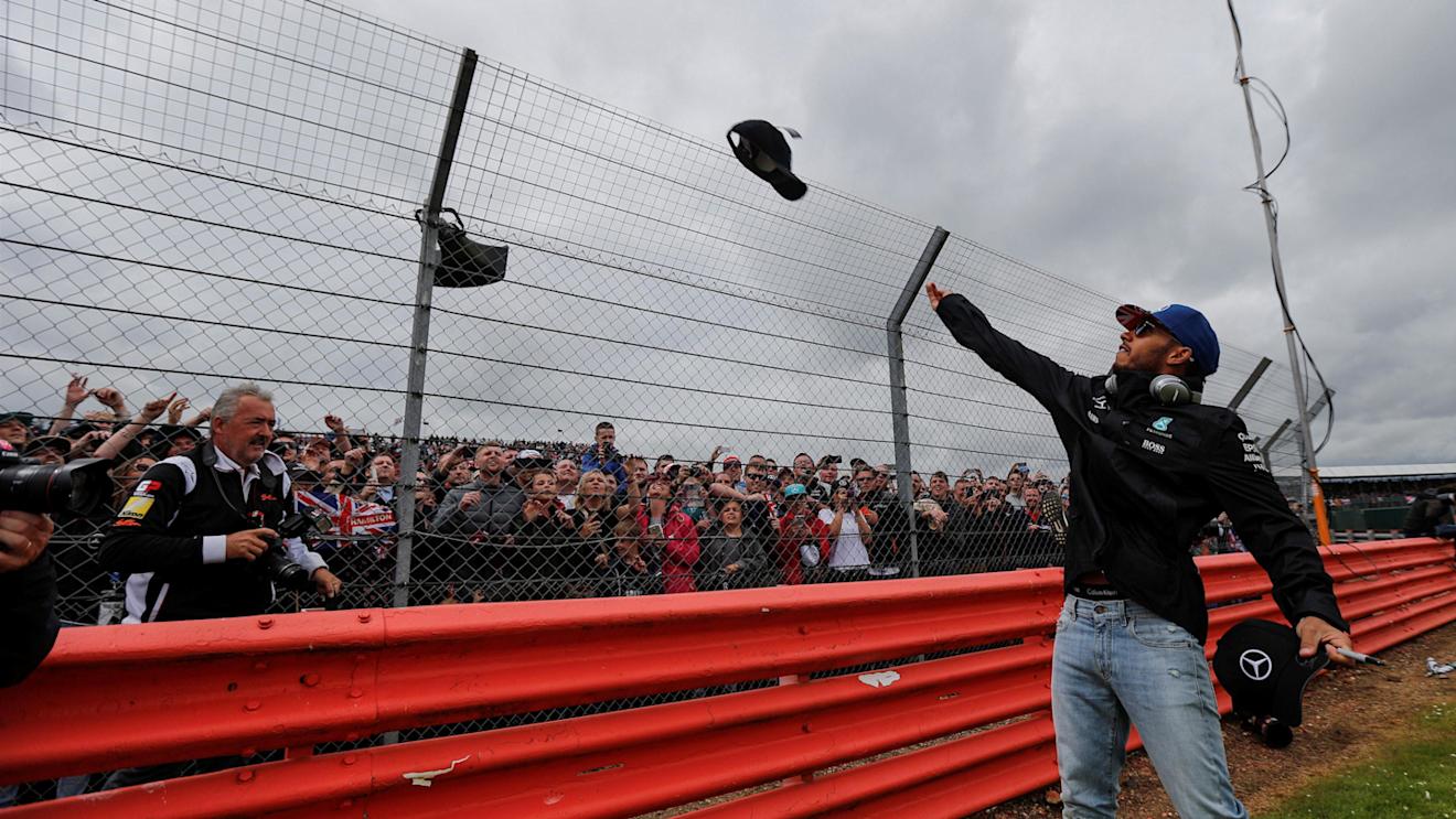 Lewis Hamilton (GBR) Mercedes AMG F1 throws caps to the fans on the drivers parade at Formula One World Championship, Rd10, British Grand Prix, Race, Silverstone, England, Sunday 10 July 2016. © Sutton Images