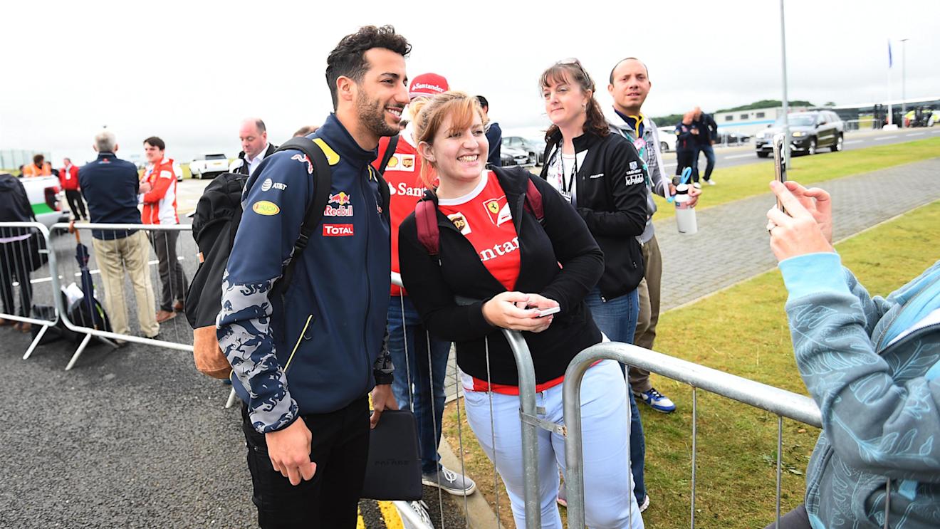 Daniel Ricciardo (AUS) Red Bull Racing poses for a photograph with a fan at Formula One World Championship, Rd10, British Grand Prix, Race, Silverstone, England, Sunday 10 July 2016. © Sutton Images