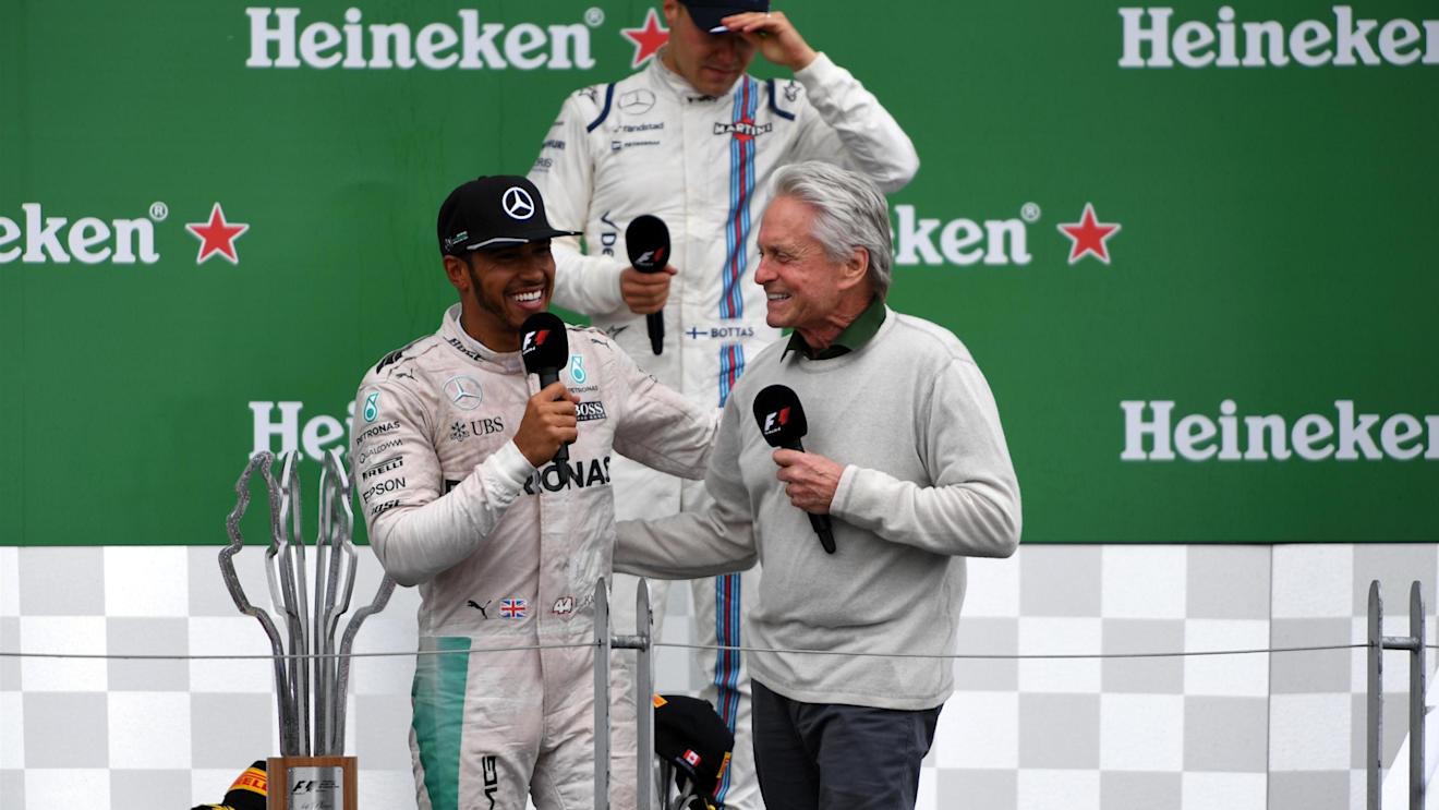 Race winner Lewis Hamilton (GBR) Mercedes AMG F1 on the podium with Michael Douglas (USA) at Formula One World Championship, Rd7, Canadian Grand Prix, Race, Montreal, Canada, Sunday 12 June 2016. © Sutton Images