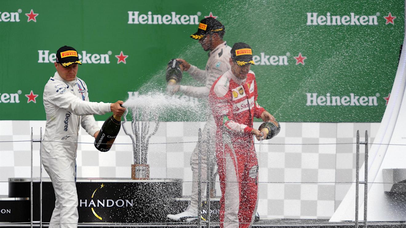 Valtteri Bottas (FIN) Williams, Lewis Hamilton (GBR) Mercedes AMG F1 and Sebastian Vettel (GER) Ferrari celebrate on the podium with the champagne at Formula One World Championship, Rd7, Canadian Grand Prix, Race, Montreal, Canada, Sunday 12 June 2016. © Sutton Images