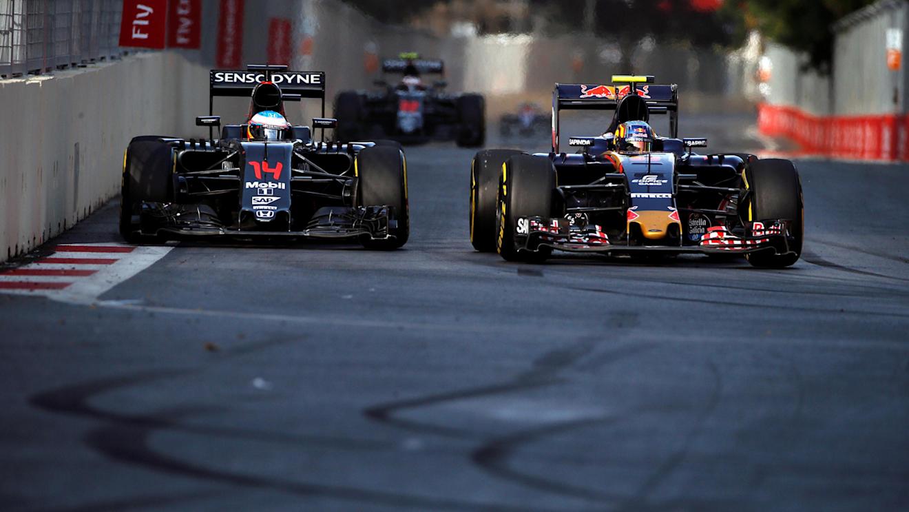 Fernando Alonso (ESP) McLaren MP4-31 and Carlos Sainz jr (ESP) Scuderia Toro Rosso STR11 battle for position at the start of the race at Formula One World Championship, Rd8, European Grand Prix, Race, Baku City Circuit, Baku, Azerbaijan, Sunday 19 June 2016. © Sutton Images