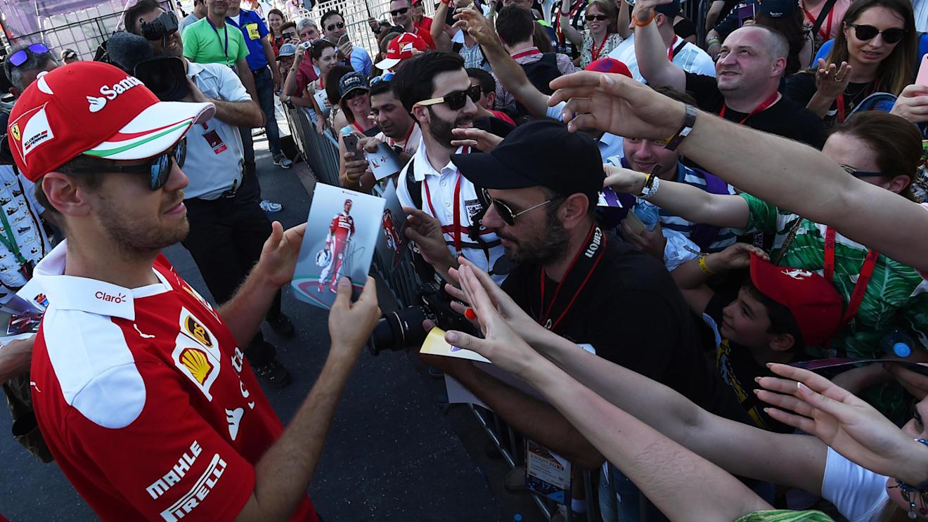 Sebastian Vettel (GER) Ferrari autographs for the fans at Formula One World Championship, Rd8, European Grand Prix, Preparations, Baku City Circuit, Baku, Azerbaijan, Thursday 16 June 2016. © Sutton Images