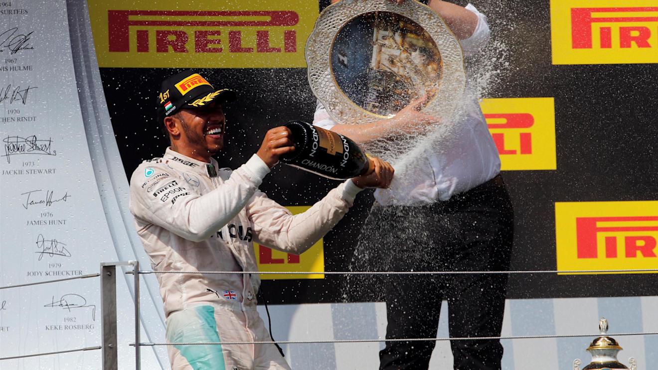 Race winner Lewis Hamilton (GBR) Mercedes AMG F1 and Ron Meadows (GBR) Mercedes AMG F1 Team Manager celebrate on the podium with the champagne and the trophy at Formula One World Championship, Rd11, Hungarian Grand Prix, Race, Hungaroring, Hungary, Sunday 24 July 2016. © Sutton Images