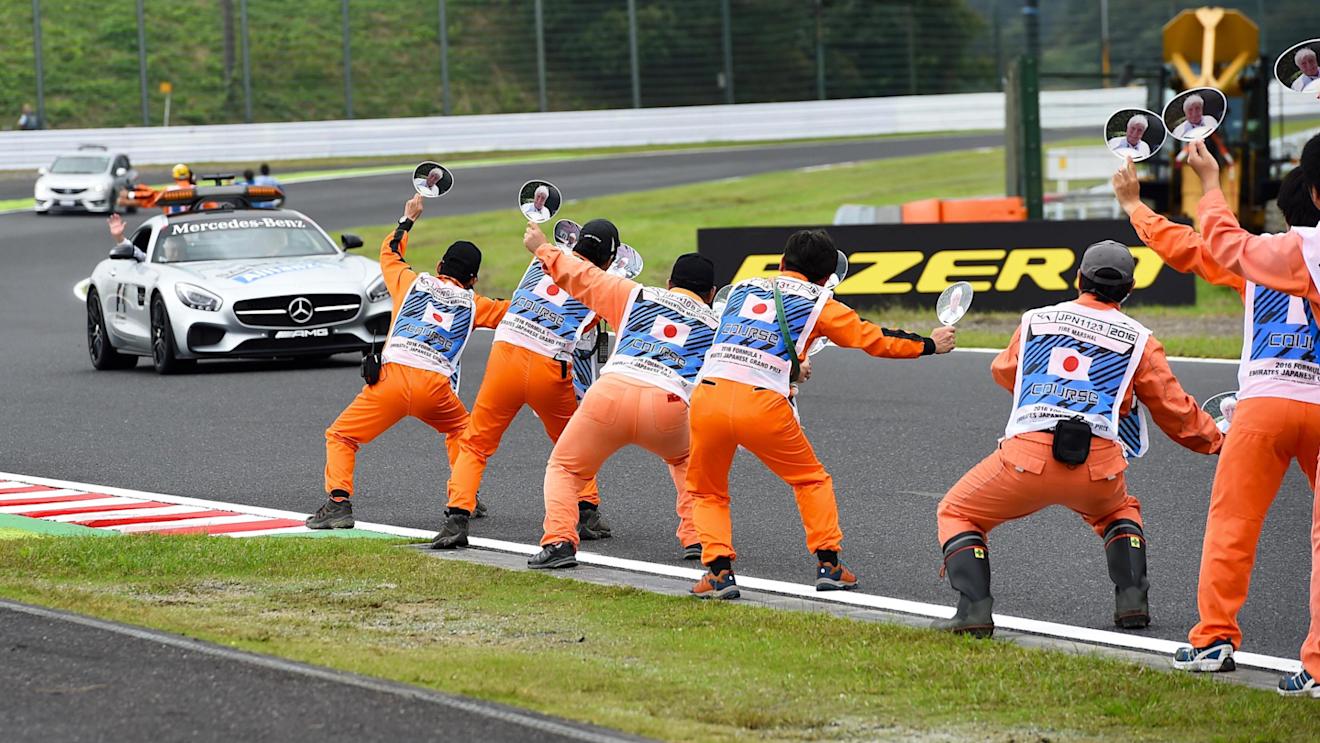 Marshals wave banners for Herbie Blash (GBR) FIA Delegate at the safety car at Formula One World Championship, Rd17, Japanese Grand Prix, Qualifying, Suzuka, Japan, Saturday 8 October 2016. © Sutton Images